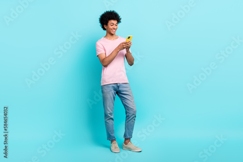 Full length body cadre of youngster handsome guy blogging read phone browsing google choose best offer isolated on aquamarine color background © deagreez