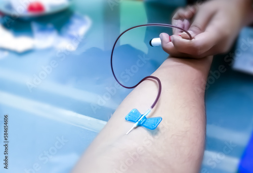 Blood collection using venipuncture technique in arm for biological analysis, phlebotomist.