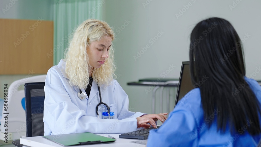 Woman doctor in white coat working and typing patient's history on laptop computer keyboard at medical office Woman doctor in white coat working and typing patient's history on laptop computer keyboard at medical office