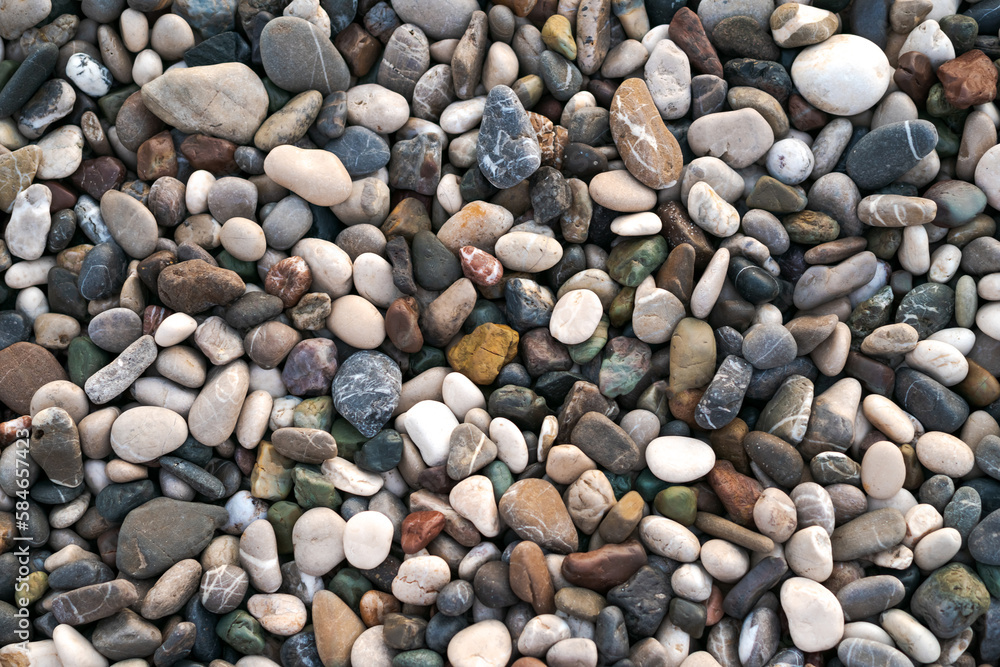 Smooth round wet pebbles texture background. Pebble sea beach close-up Smooth round wet pebbles texture background. Pebble sea beach close-up
