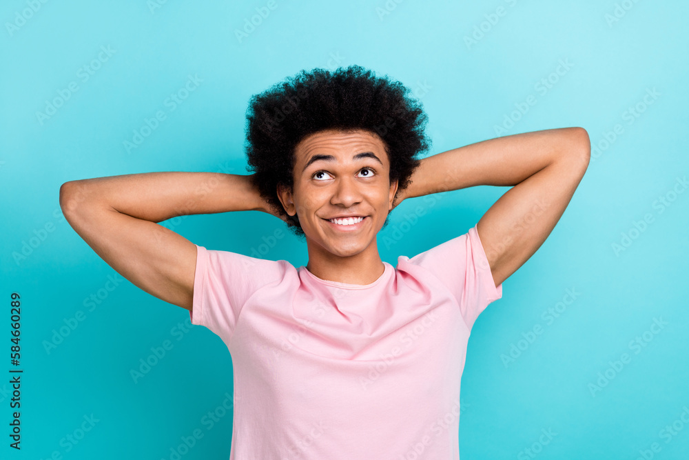 Portrait photo of relaxed nap hands head student man wear pink t-shirt look dreamy empty space new travel offer isolated on blue color background Portrait photo of relaxed nap hands head student man wear pink t-shirt look dreamy empty space new travel offer isolated on blue color background