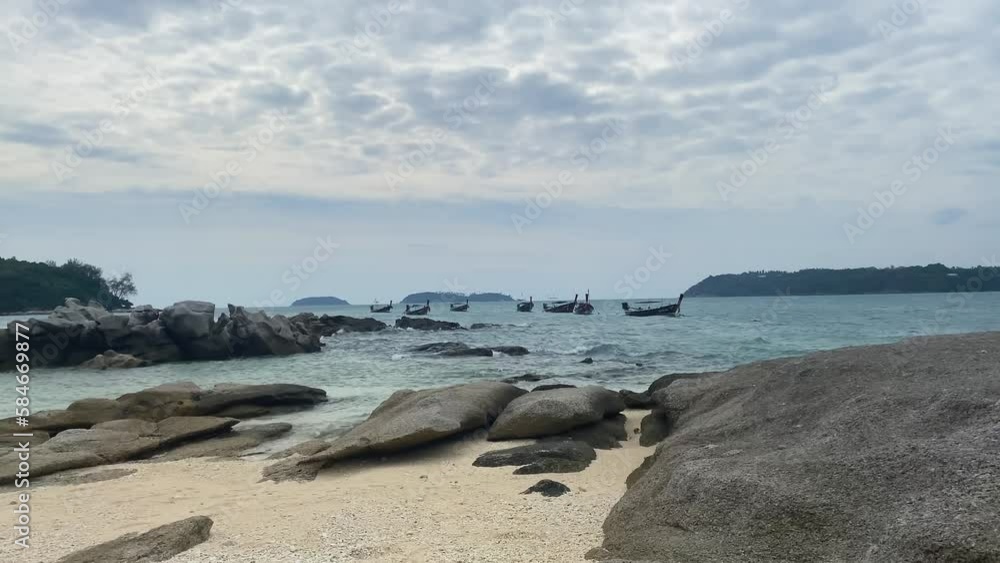 Many wooden boats are standing near the rocky shore. Many wooden boats are standing near the rocky shore.