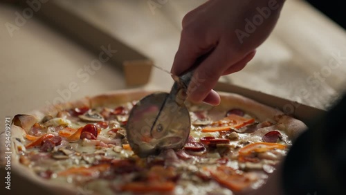 Cooking, Professional chef cooks Responsibly Slicing with a metal circular knife in the bakery shop General view Professional assistant chef Serves customers food ordering place, street eatery
 photo