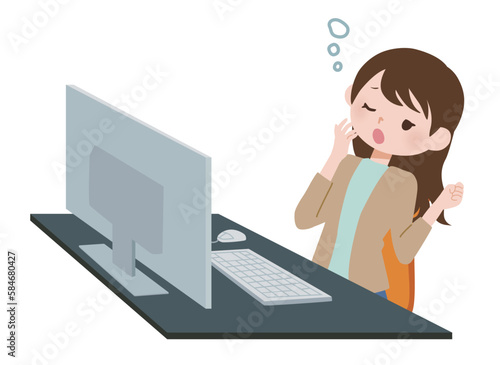 パソコンの前であくびをする女性　私服