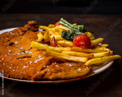 Cachopo Asturiano, dos filetes de ternera empanados rellenos de queso y jamón photo