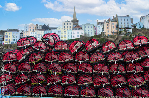 Tenby  Pembrokeshire  colourful houses  against  new  lobster and  crab pots  photo