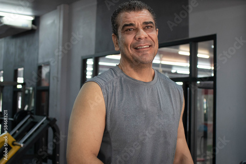 portrait of a man workout on a fitness machine at gym