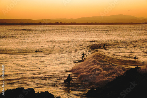 Obraz na plátně Golden hour sunset surf session in Byron Bay, Australia.