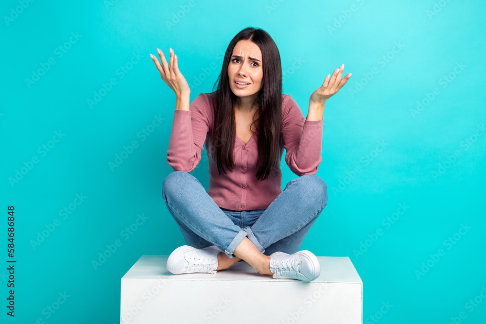 Full body length photo of hesitant lady shrug shoulders unhappy questioned what happened sit white platform isolated on cyan color background - obrazy, fototapety, plakaty 