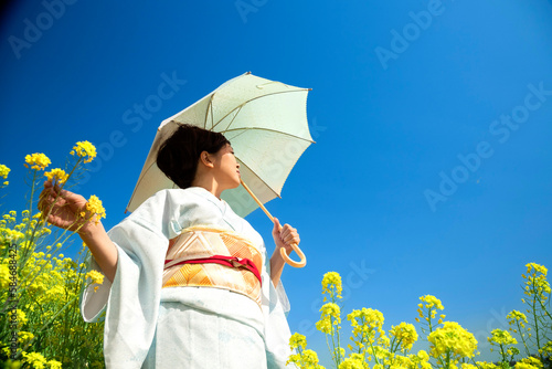 Japanese woman in a beautiful yellow flowers field