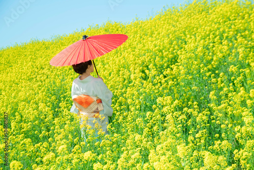 Japanese woman in a beautiful yellow flowers field