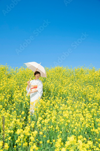 Japanese woman in a beautiful yellow flowers field