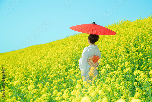 Japanese woman in a beautiful yellow flowers field