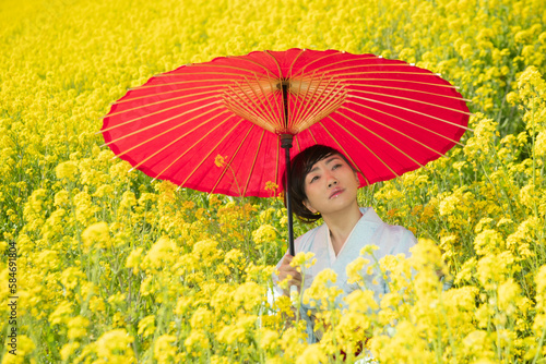Japanese woman in a beautiful yellow flowers field