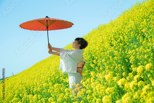 Japanese woman in a beautiful yellow flowers field