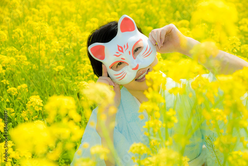 Japanese woman in a beautiful yellow flowers field