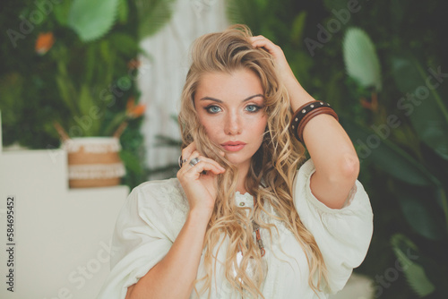 Portrait of sensual model woman with blonde curly hair portrait