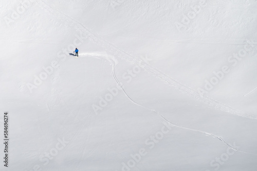 Single offpiste skier making fresh tracks in powder snow photo