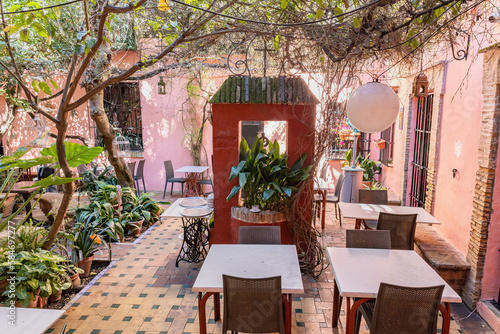 Beautiful empty restaurant terrace in the Santa Cruz neighborhood, in Seville city old center, Andalusia, Spain