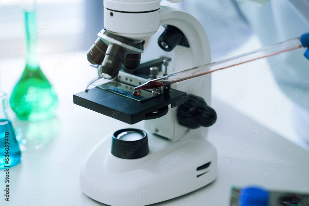 Lab work, Doctor holds a test tube takes the test from a test tube in analysis, blood, DNA, test tube stand. Lab work, Doctor holds a test tube takes the test from a test tube in analysis, blood, DNA, test tube stand.
