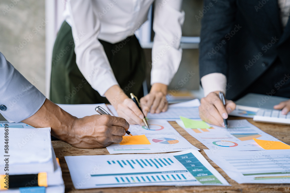 Businessmen team or financial data analysts working with tablets and laptop computers and data graphs together. Plan to analyzing projects. Businessmen team or financial data analysts working with tablets and laptop computers and data graphs together. Plan to analyzing projects.