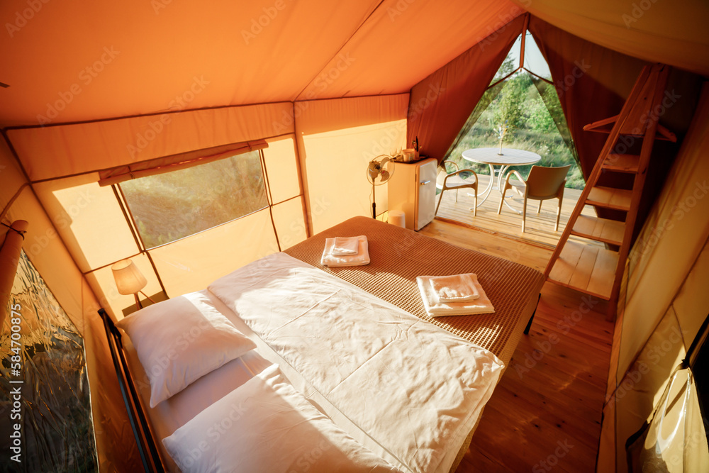 Interior of Cozy open glamping tent with light inside during sunset. Luxury  camping tent for outdoor summer holiday and vacation. Lifestyle concept  Photos | Adobe Stock