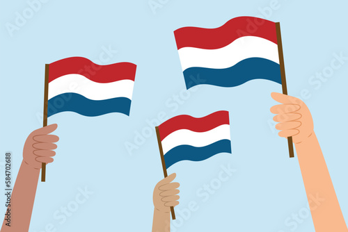 Different hands holding Dutch flags. Flag of the Netherlands. Vector illustration in flat style isolated on blue background.