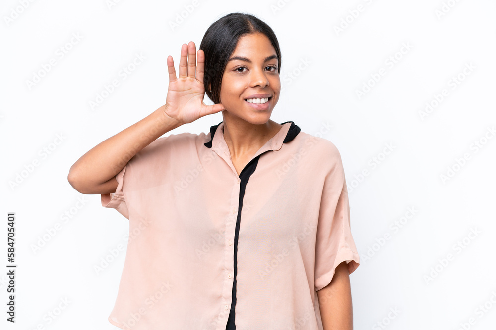 Young African american woman isolated on white background listening to something by putting hand on the ear Young African american woman isolated on white background listening to something by putting hand on the ear