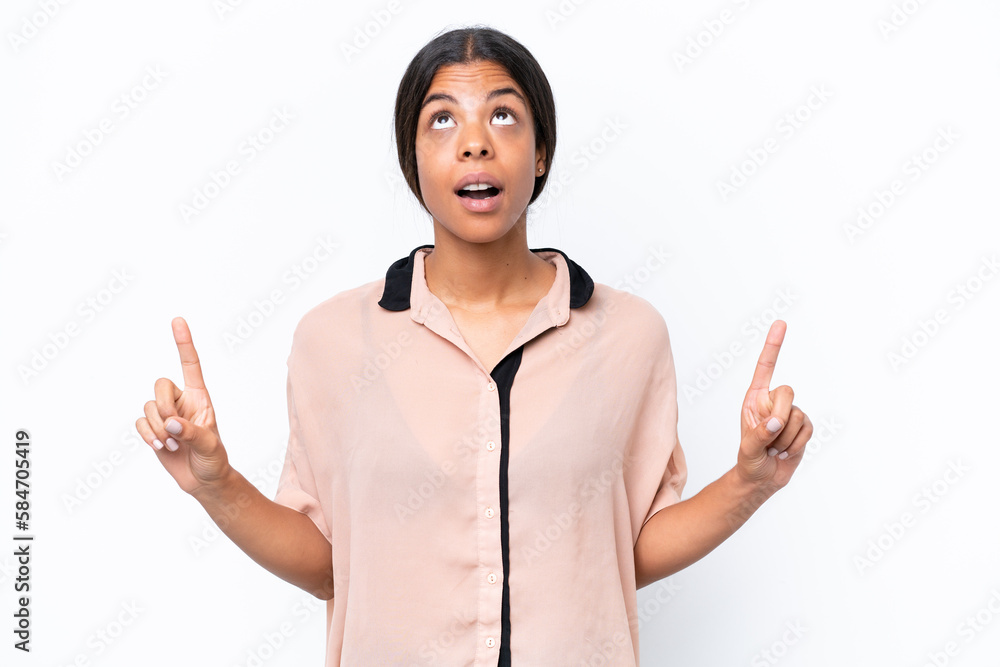 Young African american woman isolated on white background surprised and pointing up Young African american woman isolated on white background surprised and pointing up