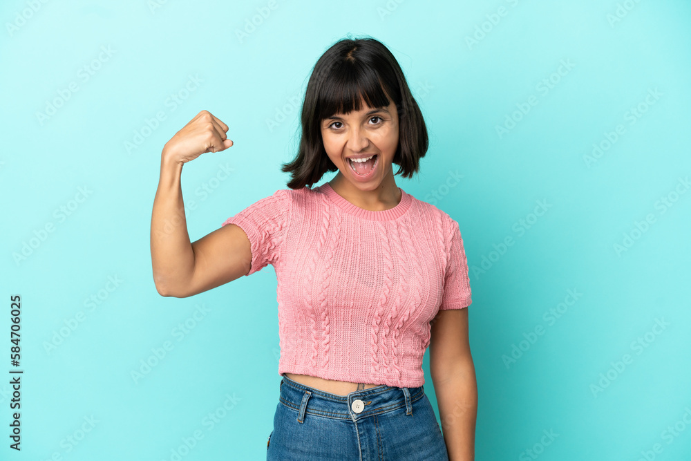 Young mixed race woman isolated on blue background celebrating a victory Young mixed race woman isolated on blue background celebrating a victory