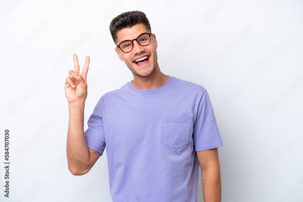 Young caucasian man isolated on white background smiling and showing victory sign Young caucasian man isolated on white background smiling and showing victory sign