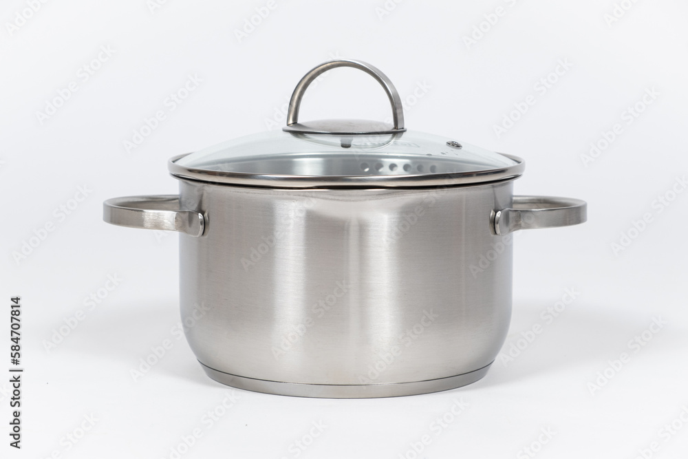 Stainless steel pot with glass lid and drain spout on a white background. Stainless steel pot with glass lid and drain spout on a white background.