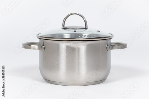 Stainless steel pot with glass lid and drain spout on a white background.