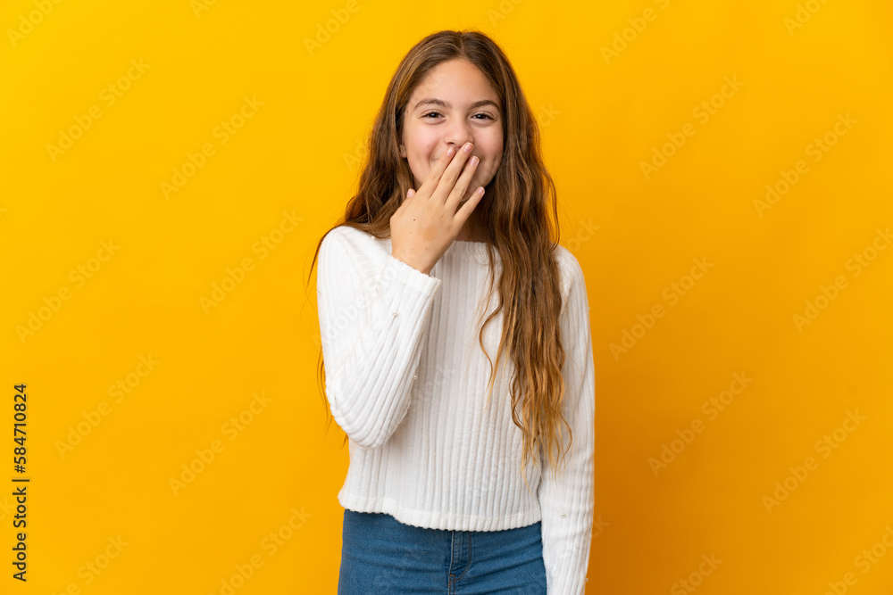 Child over isolated yellow background happy and smiling covering mouth with hand Child over isolated yellow background happy and smiling covering mouth with hand