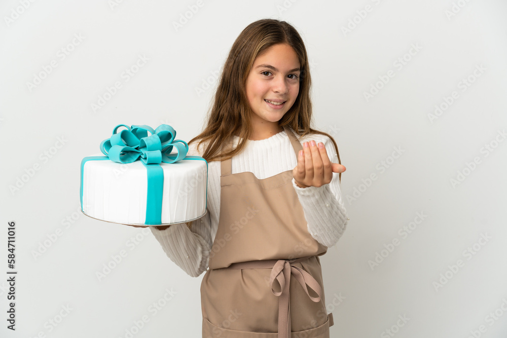 Little girl holding a big cake over isolated white background inviting to come with hand. Happy that you came Little girl holding a big cake over isolated white background inviting to come with hand. Happy that you came