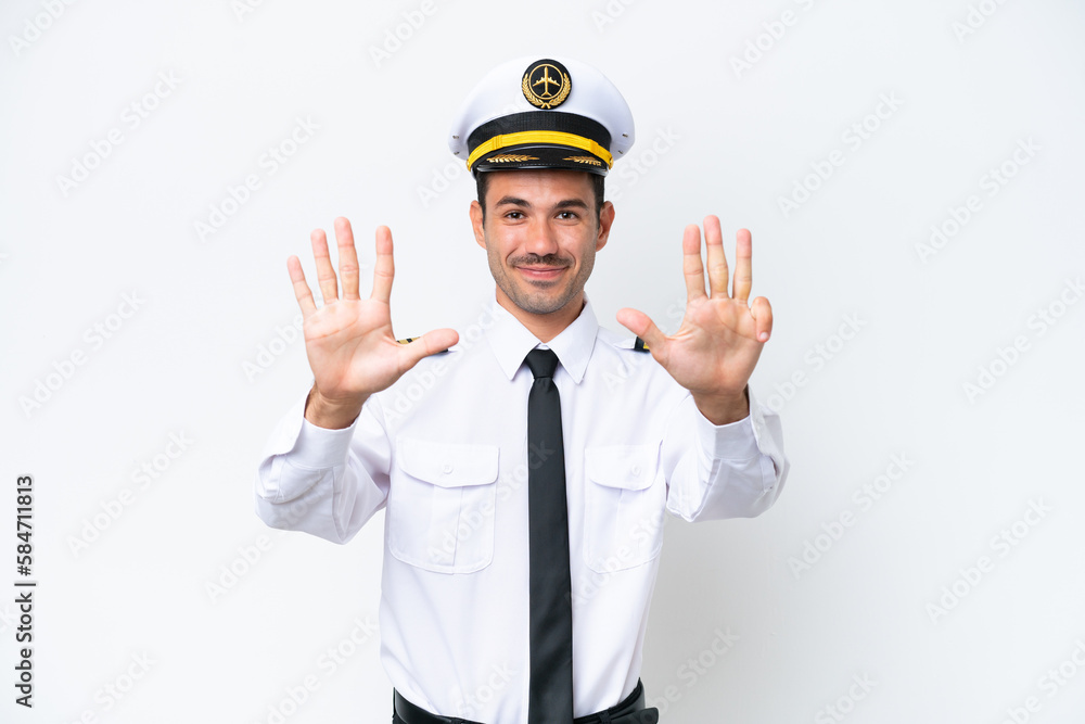 Airplane pilot over isolated white background counting nine with fingers