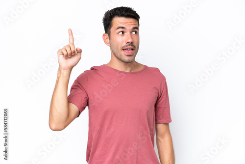 Young handsome man over isolated white background intending to realizes the solution while lifting a finger up