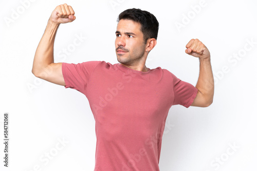 Young handsome man over isolated white background doing strong gesture