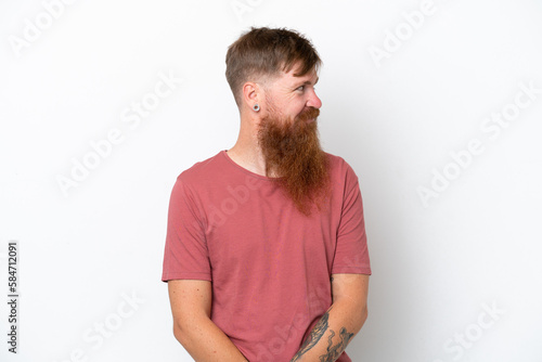 Redhead man with long beard isolated on white background looking to the side