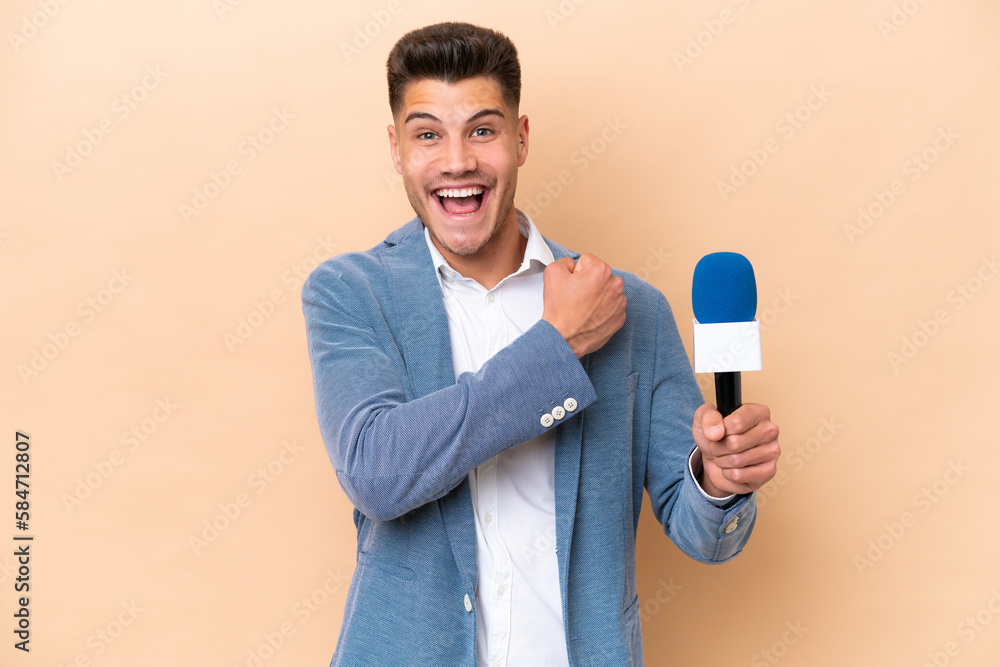 Young caucasian TV presenter man isolated on white background celebrating a victory Young caucasian TV presenter man isolated on white background celebrating a victory