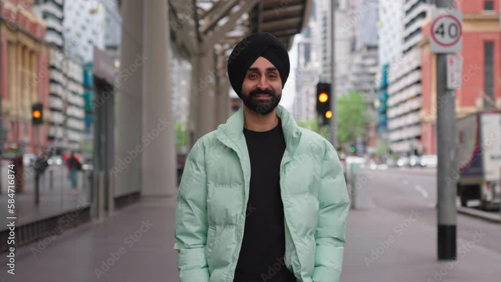Young Indian Punjabi Sikh Man Looks To The Camera Then Smile. - close up Young Indian Punjabi Sikh Man Looks To The Camera Then Smile. - close up