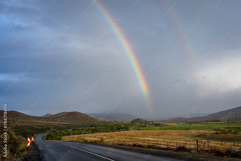 A rainbow after a Karoo storm along the N12 just outside Klaarstroom. Western Cape. South Africa A rainbow after a Karoo storm along the N12 just outside Klaarstroom. Western Cape. South Africa