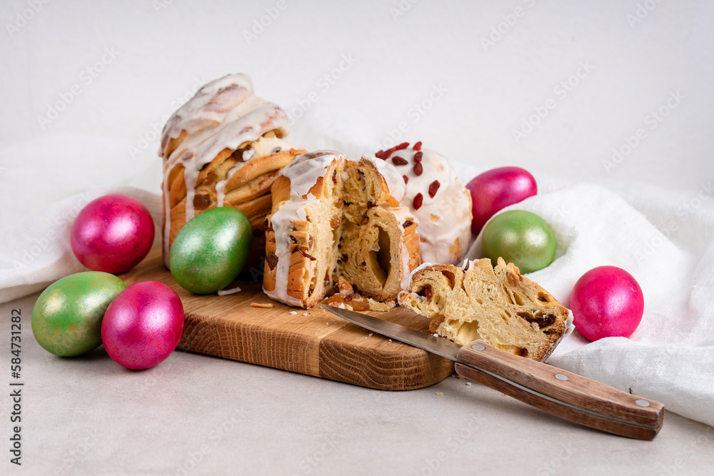 Easter cakes with white icing and a knife and colored eggs Easter cakes with white icing and a knife and colored eggs