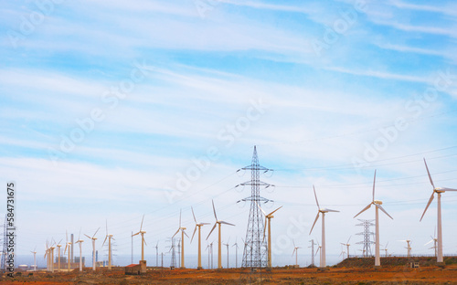 Obraz na płótnie Wind farm with wind turbines and high voltage wires w salonie