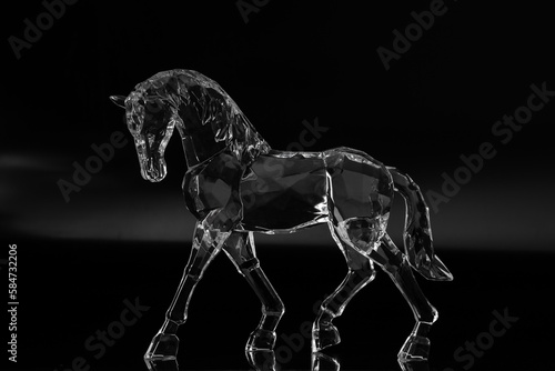 Crystal horse on black background. Low key.