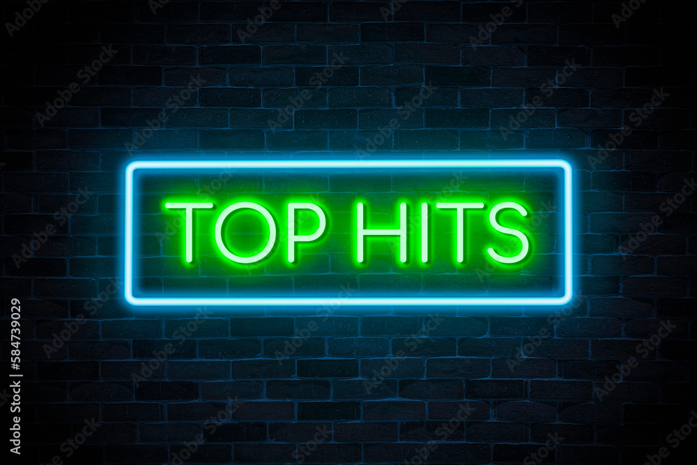 Top hits neon banner on brick wall background. Top hits neon banner on brick wall background.
