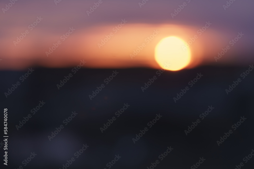 Bokeh photo of sunset over city in winter