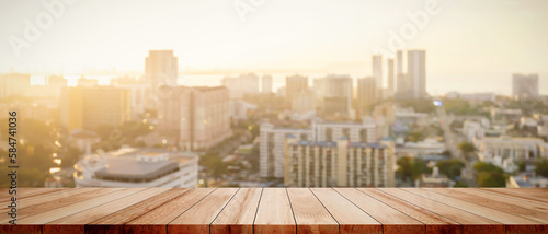 Wood table top on white bokeh blurred city sunset background building hallway for display or montage mock up products Blurred dark night city background on perspective wooden panels blur glass window.