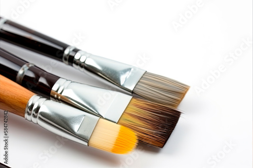 Composition of painting brushes on white background