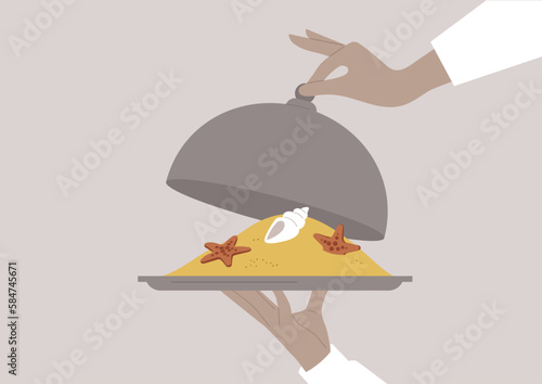 Waiter holding a tray and lifting a cloche, revealing a dessert served under the lid that resembles beach sand with sea stars and shells